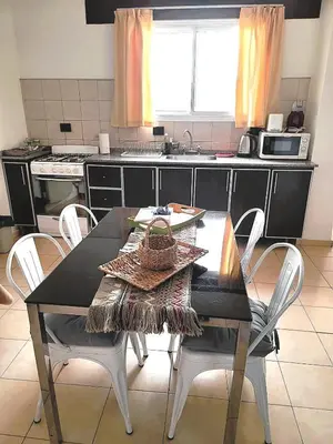 a kitchen with a table and chairs in a kitchen at Mujer Urbana Suite in Cordoba