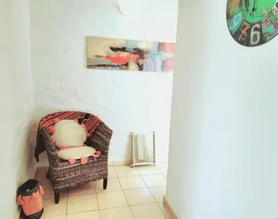 a teddy bear sitting in a chair in a room at Mujer Urbana Suite in Cordoba