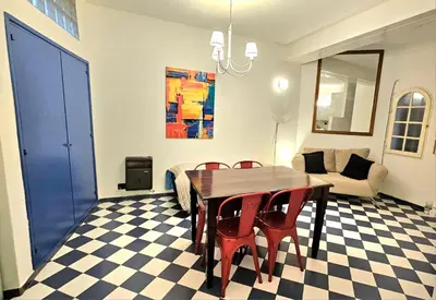 a dining room with a table and chairs and a couch at Mujer Urbana Suite in Cordoba