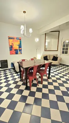 a dining room with a table and chairs on a checkered floor at Mujer Urbana Suite in Cordoba