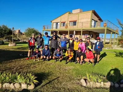 a group of people posing for a picture in front of a house at Cabañas Y Departamentos Bettylu in Villa Cura Brochero