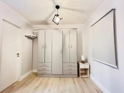 a white room with a closet and a table at Departamento 