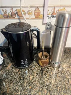 a black coffee maker sitting on top of a counter at Departamento 