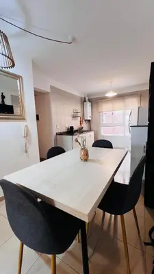 a kitchen and dining room with a wooden table and chairs at Departamento tres dormitorios excelente ubicación Nueva Córdoba in Cordoba
