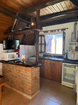 a kitchen with a microwave on a brick counter at Cabañas Pindahue - Alojamineto Epehuen in Villa Carlos Paz