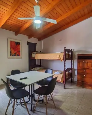 a dining room with a table and chairs and a bunk bed at La caballeriza departamentos in Alta Gracia