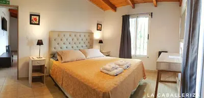 a bedroom with a bed with towels on it at La caballeriza departamentos in Alta Gracia