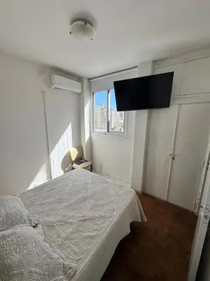 a bedroom with a bed and a flat screen tv at Centro Cordoba in Cordoba