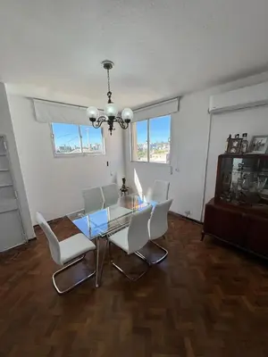 a dining room with a glass table and white chairs at Centro Cordoba in Cordoba