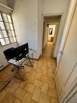 a hallway with a table and a chair in a room at Centro Cordoba in Cordoba