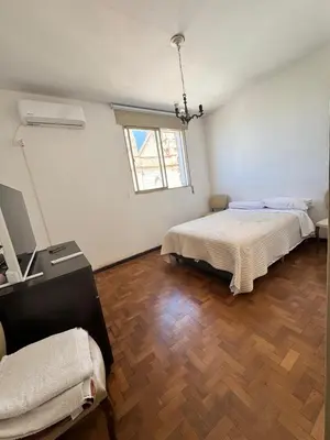 a bedroom with two beds and a wooden floor at Centro Cordoba in Cordoba