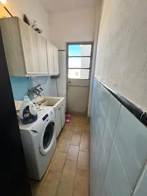 a laundry room with a washing machine and a window at Centro Cordoba in Cordoba