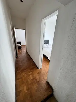 a hallway with a bedroom and a bed in a room at Centro Cordoba in Cordoba