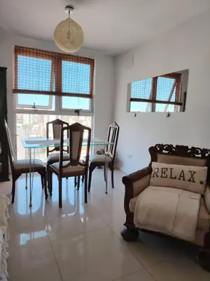 a living room with a glass table and chairs at Güemes Premium, 1 dorm Ubicación Estratégica ALOHA #5 in Cordoba