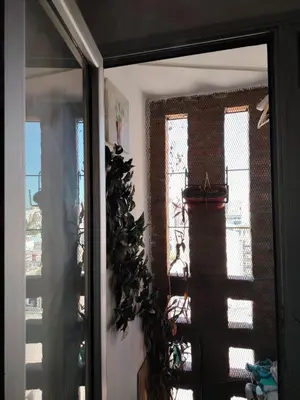 a door to a room with a window and a plant at Güemes Premium, 1 dorm Ubicación Estratégica ALOHA #5 in Cordoba