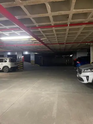 a parking garage with two cars parked in it at Güemes Premium, 1 dorm Ubicación Estratégica ALOHA #5 in Cordoba