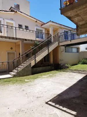 a house with a staircase in front of it at Melodía del lago in Villa Carlos Paz