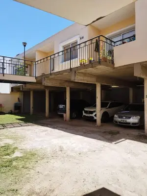 a house with two cars parked in the garage at Melodía del lago in Villa Carlos Paz
