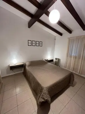 a bedroom with a large bed and two night stands at Melodía del lago in Villa Carlos Paz
