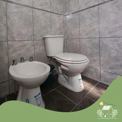 a bathroom with a toilet and a sink at Punilla- Don Americo in Villa Carlos Paz