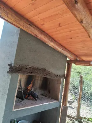 an outdoor oven with a fire in it at Punilla- Don Americo in Villa Carlos Paz