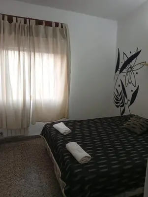 a bedroom with a bed with two towels on it at Hotel inti huasi in Villa Carlos Paz