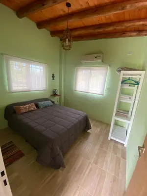 a bedroom with a bed and a wooden ceiling at La Herminda Casas de Campo in Nono
