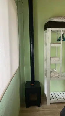 a room with a stove in a room with a bunk bed at La Herminda Casas de Campo in Nono