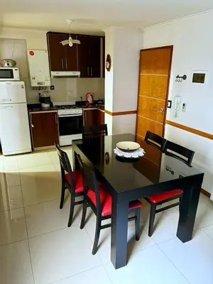 a kitchen with a black dining table and chairs at DPto Carlos Paz in Villa Carlos Paz