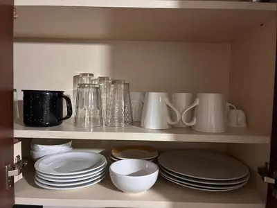 a shelf filled with plates and cups and dishes at DPto Carlos Paz in Villa Carlos Paz