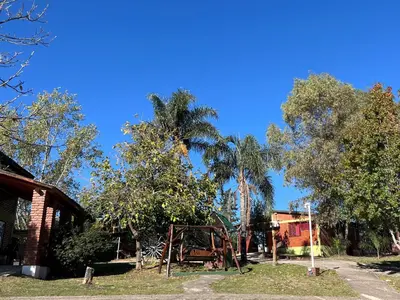 a park with trees and an old playground at Cabañas Antílope & Spa in Tanti