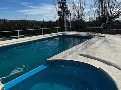 a large swimming pool with blue water at Cabañas Antílope & Spa in Tanti