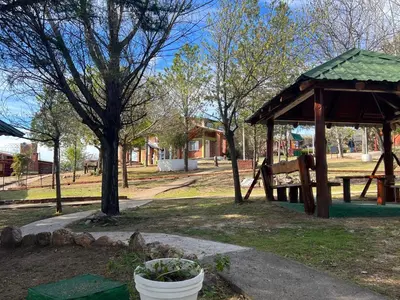 a park with a playground with a bench and a pavilion at Cabañas Antílope & Spa in Tanti