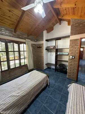 a bedroom with a bed and a ceiling fan at El refugio in Villa del Dique
