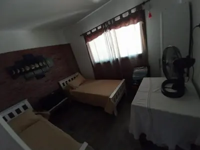 a small room with a bed and a window at La Morada del Arroyo in Villa Parque Siquiman