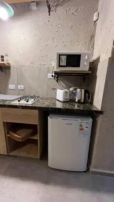 a kitchen with a counter with a microwave and a refrigerator at Terrazas Suite in Potrero de Garay