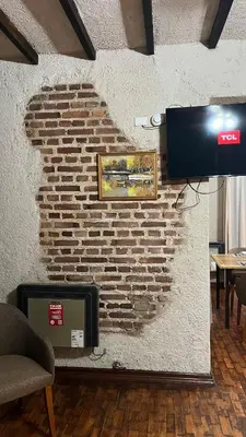 a wall with a brick wall with a tv on it at Terrazas Suite in Potrero de Garay
