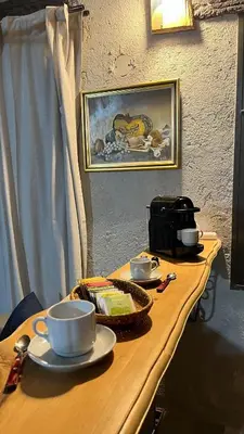 a wooden table with cups and saucers on it at Terrazas Suite in Potrero de Garay