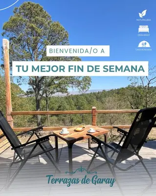 a wooden table and two chairs on a deck at Terrazas Suite in Potrero de Garay