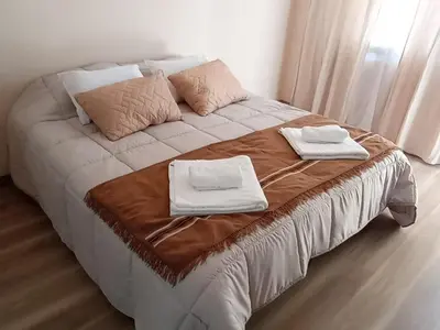 a bed with two towels on top of it at Monoambiente Villa Carlos Paz Centro, Terminal in Cordoba