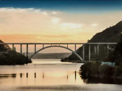 a bridge over a body of water with a bridge at Monoambiente Villa Carlos Paz Centro, Terminal in Cordoba