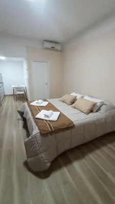 a bedroom with a large bed with two tables on it at Monoambiente Villa Carlos Paz Centro, Terminal in Cordoba