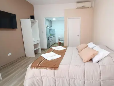 a bedroom with a large bed with two towels on it at Monoambiente Villa Carlos Paz Centro, Terminal in Cordoba