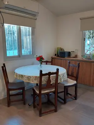 a table and chairs in a kitchen with a table at Casa en Villa General Belgrano in Villa General Belgrano