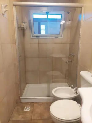 a bathroom with a shower and a toilet and a sink at Casa en Villa General Belgrano in Villa General Belgrano