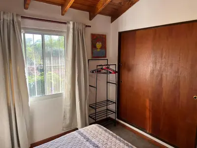 a bedroom with a bed and a wooden door at La mejor vista in Villa General Belgrano