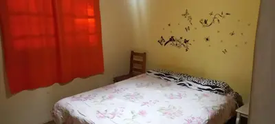 a bedroom with a bed and a window with butterflies on the wall at Cabaña Cerca del rio Cabalango in Cavalango