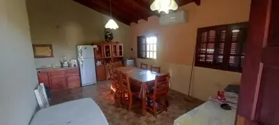a kitchen with a table and a white refrigerator at Cabaña Cerca del rio Cabalango in Cavalango