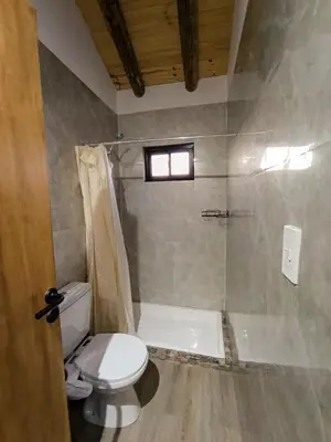 a bathroom with a toilet and a shower at Piedras Blancas in La Bajada