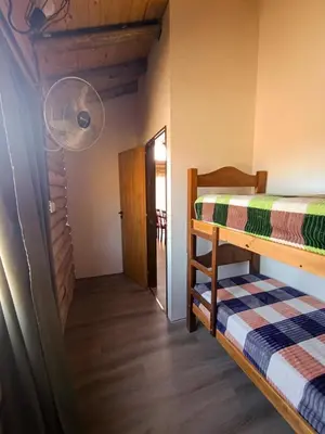 a room with two bunk beds and a hallway at Piedras Blancas in La Bajada